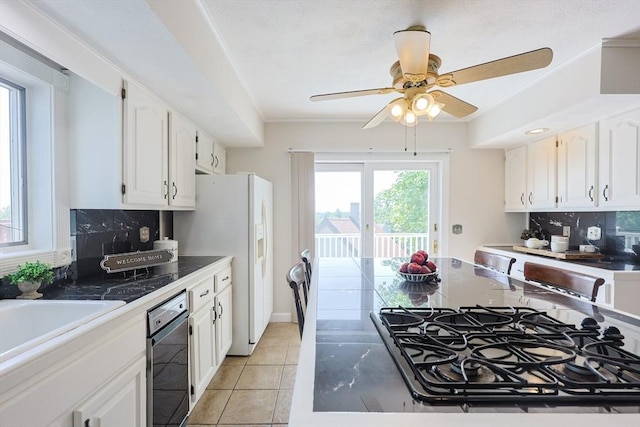 3 Nira St, Malden, MA 02148 - kitchen featuring black gas stovetop, white cabinetry, decorative backsplash, white fridge with ice dispenser, and ceiling fan