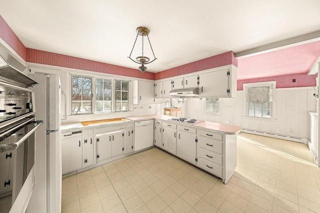 kitchen with white cabinetry, baseboard heating, a wealth of natural light, pendant lighting, and white appliances