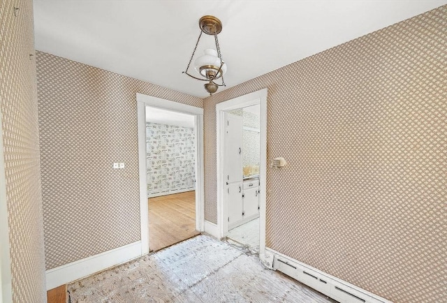 entryway featuring a baseboard heating unit and light hardwood / wood-style flooring