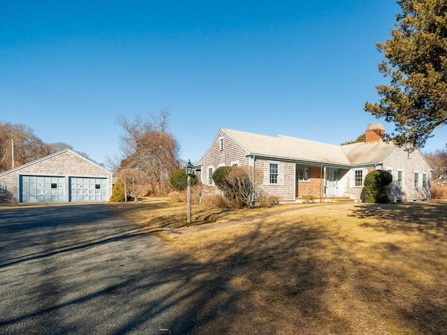 view of front of property featuring a garage and a front lawn