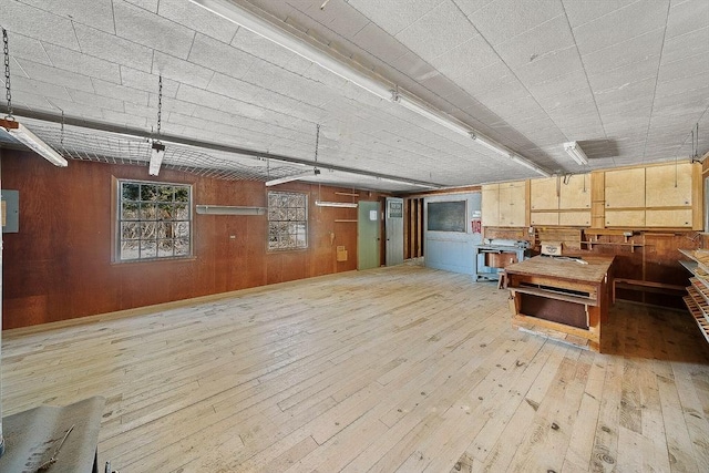 interior space with wooden walls and light hardwood / wood-style flooring