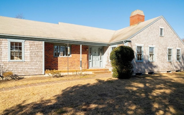 rear view of house featuring a yard