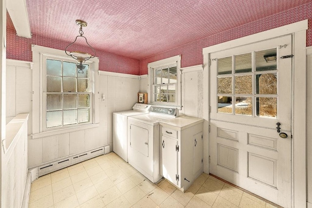 laundry room featuring a baseboard radiator and washing machine and dryer