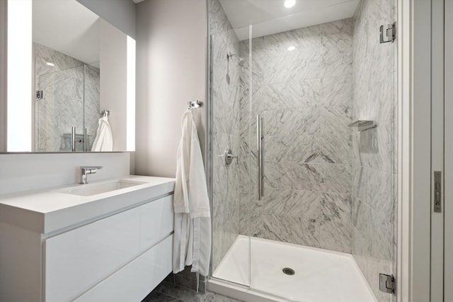 bathroom featuring vanity and a shower with door