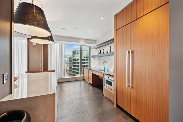 kitchen featuring dark wood-type flooring, sink, and white oven