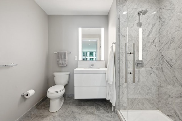 bathroom featuring a shower with door, vanity, and toilet