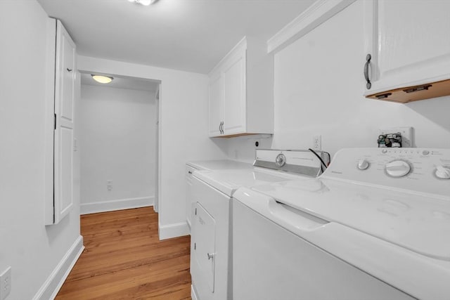 680 Old Connecticut Path, Framingham, MA 01701 - clothes washing area featuring washing machine and clothes dryer, cabinet space, light wood-style floors, and baseboards