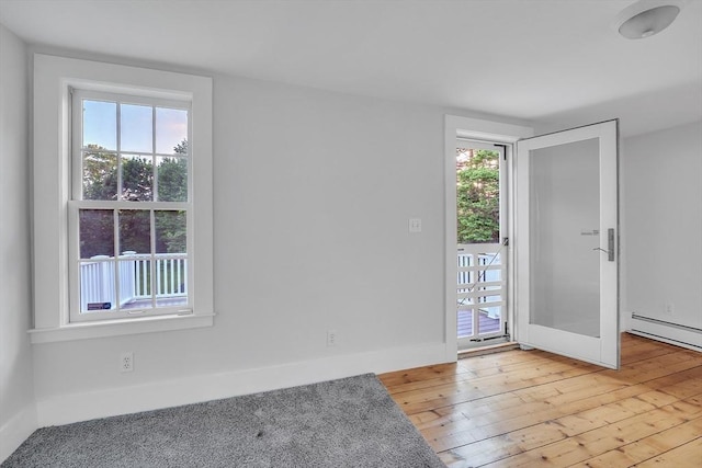 680 Old Connecticut Path, Framingham, MA 01701 - entrance foyer featuring light wood-style floors, healthy amount of natural light, baseboards, and a baseboard radiator