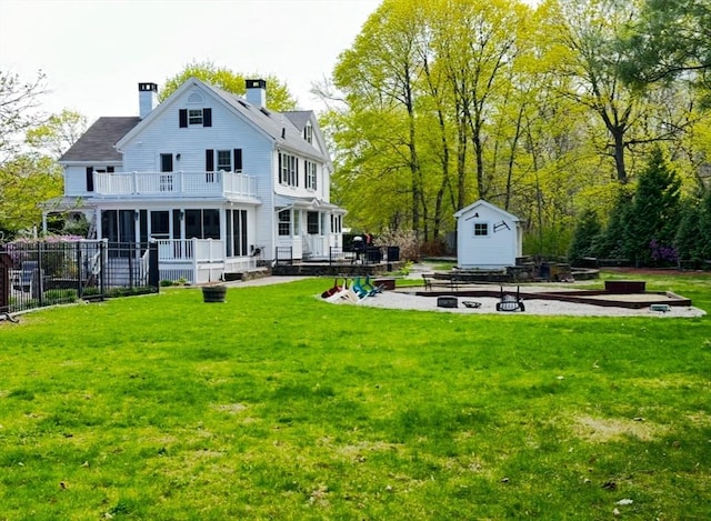 680 Old Connecticut Path, Framingham, MA 01701 - rear view of property with a balcony, a shed, an outdoor structure, a chimney, and an outdoor fire pit