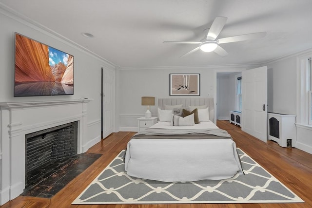 680 Old Connecticut Path, Framingham, MA 01701 - bedroom featuring a fireplace with flush hearth, wood finished floors, ornamental molding, and ceiling fan