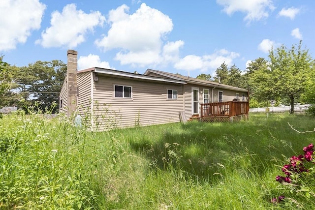 view of side of property featuring a deck