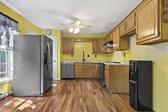 kitchen featuring ceiling fan, sink, a baseboard radiator, stainless steel appliances, and dark hardwood / wood-style floors