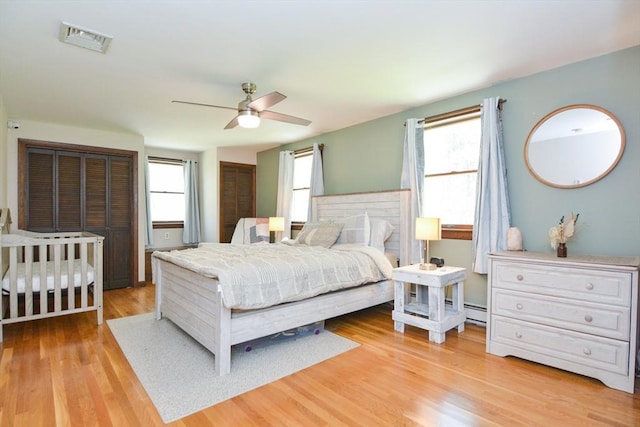 133 E Main St, Norton, MA 02766 - bedroom featuring multiple windows, light wood-style flooring, baseboard heating, and ceiling fan