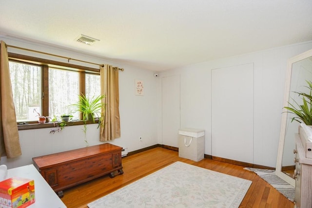 133 E Main St, Norton, MA 02766 - bedroom with wood finished floors, a baseboard radiator, and baseboards