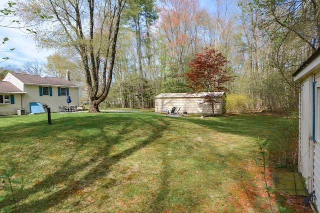 133 E Main St, Norton, MA 02766 - view of green lawn featuring an outdoor structure and central AC