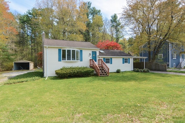 133 E Main St, Norton, MA 02766 - view of front of property with a chimney, a front lawn, gravel driveway, an outdoor structure, and a carport