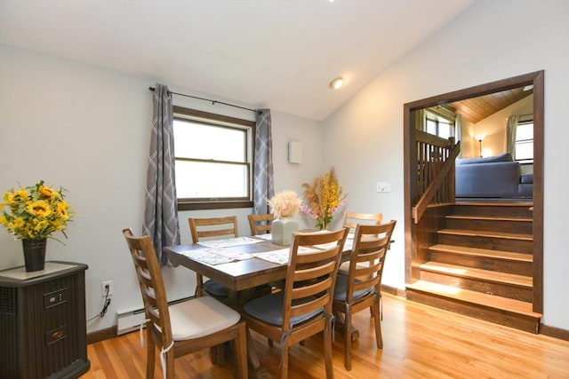 133 E Main St, Norton, MA 02766 - dining space with vaulted ceiling, light wood finished floors, stairway, and a baseboard heating unit