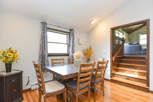 133 E Main St, Norton, MA 02766 - dining room featuring vaulted ceiling, light wood-style floors, stairway, and a baseboard heating unit