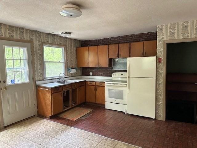 kitchen featuring white appliances, wallpapered walls, light countertops, brown cabinetry, and a textured ceiling