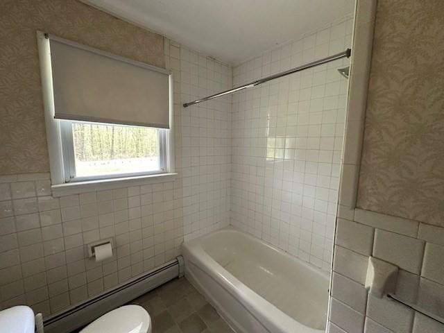 bathroom with wallpapered walls, a baseboard heating unit, toilet, tile walls, and a wainscoted wall