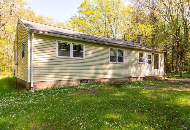view of home's exterior featuring a lawn and entry steps