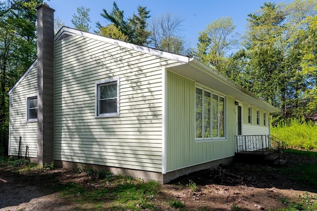 view of side of home featuring a chimney
