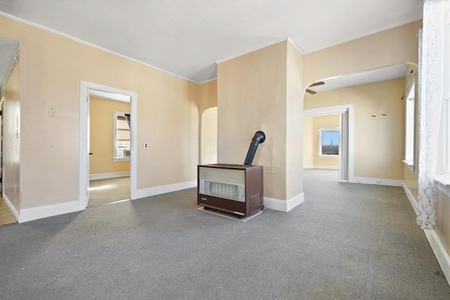 unfurnished living room featuring crown molding and baseboard heating