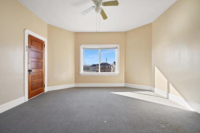 carpeted spare room with ceiling fan