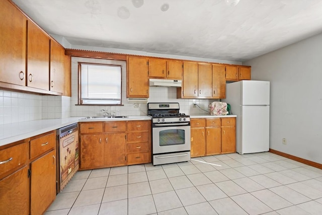 kitchen with sink, stainless steel gas stove, light tile patterned floors, white refrigerator, and dishwasher