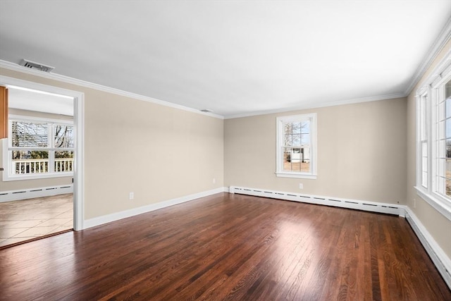 empty room featuring plenty of natural light, visible vents, and baseboard heating