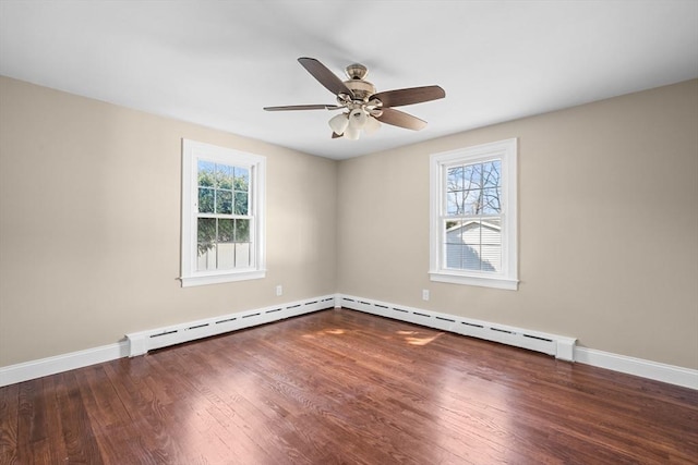 unfurnished room with a wealth of natural light, baseboards, and wood finished floors