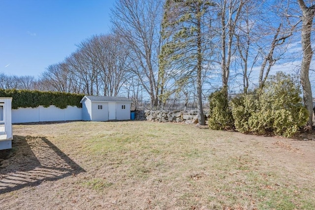 view of yard featuring an outdoor structure and fence