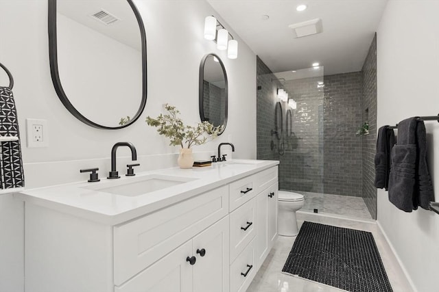 full bath with double vanity, a stall shower, a sink, and visible vents