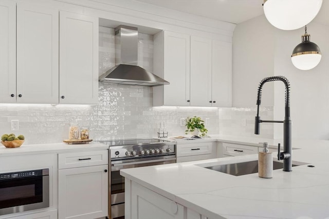 kitchen featuring white cabinets, stainless steel electric stove, wall chimney range hood, pendant lighting, and backsplash