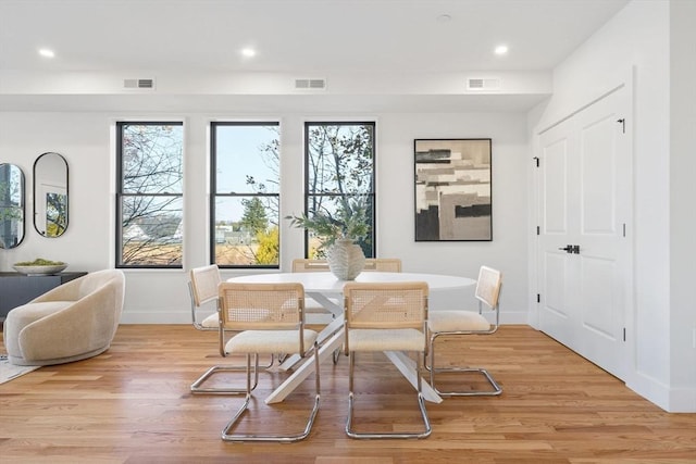 dining space featuring a wealth of natural light, light wood-type flooring, and visible vents