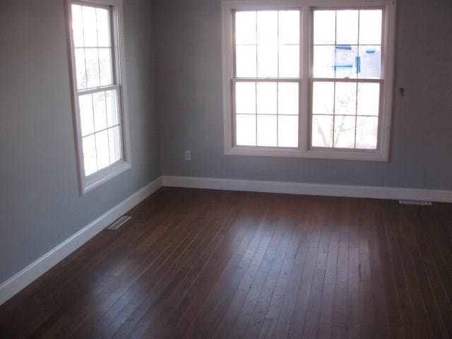 unfurnished room with dark hardwood / wood-style floors