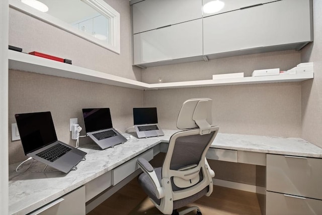 office area featuring built in desk and hardwood / wood-style flooring