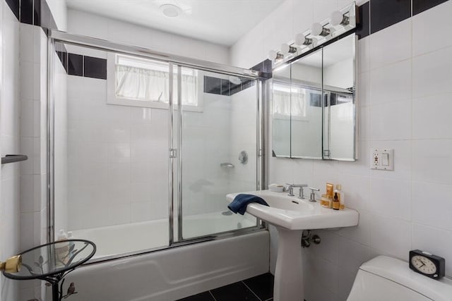 50-52 Chilton St, Cambridge, MA 02138 - bathroom featuring tile walls, shower / bath combination with glass door, and tasteful backsplash