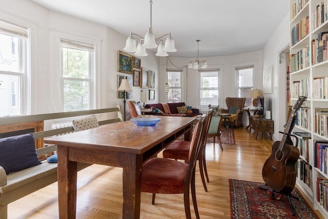 50-52 Chilton St, Cambridge, MA 02138 - dining room with a chandelier, healthy amount of natural light, and light wood-style floors