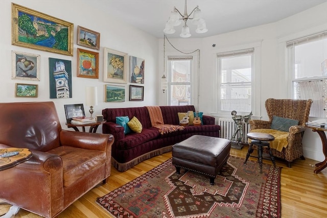 50-52 Chilton St, Cambridge, MA 02138 - living room featuring wood finished floors, radiator, and a chandelier