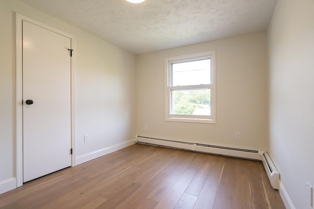 67 Paris Ave, Worcester, MA 01603 - empty room featuring wood finished floors, baseboards, a textured ceiling, and baseboard heating
