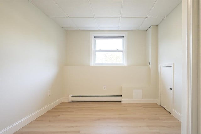67 Paris Ave, Worcester, MA 01603 - empty room with a drop ceiling, a baseboard heating unit, light wood-style floors, and baseboards