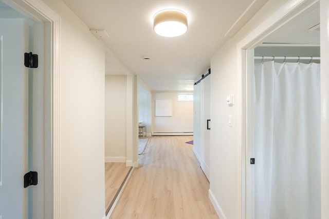 67 Paris Ave, Worcester, MA 01603 - hallway featuring light wood finished floors, a baseboard radiator, baseboards, and a barn door