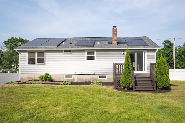 67 Paris Ave, Worcester, MA 01603 - back of property with a chimney, a deck, solar panels, and roof with shingles