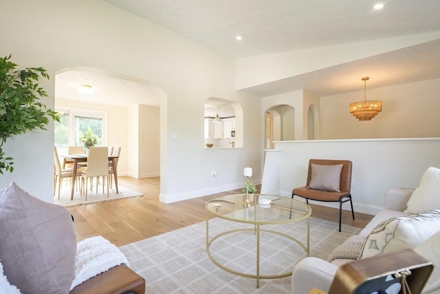 67 Paris Ave, Worcester, MA 01603 - living room with arched walkways, light wood finished floors, baseboards, vaulted ceiling, and recessed lighting