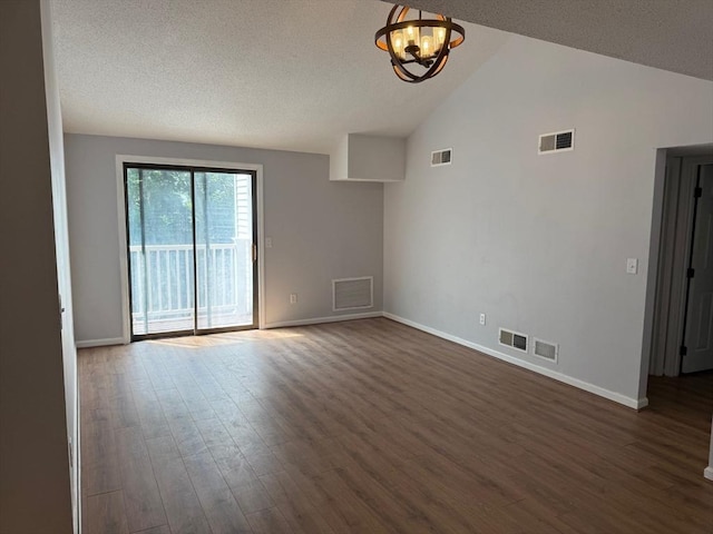 100 Cass Ave Unit B20, Dracut, MA 01826 - empty room featuring dark wood-type flooring, vaulted ceiling, a chandelier, and a textured ceiling