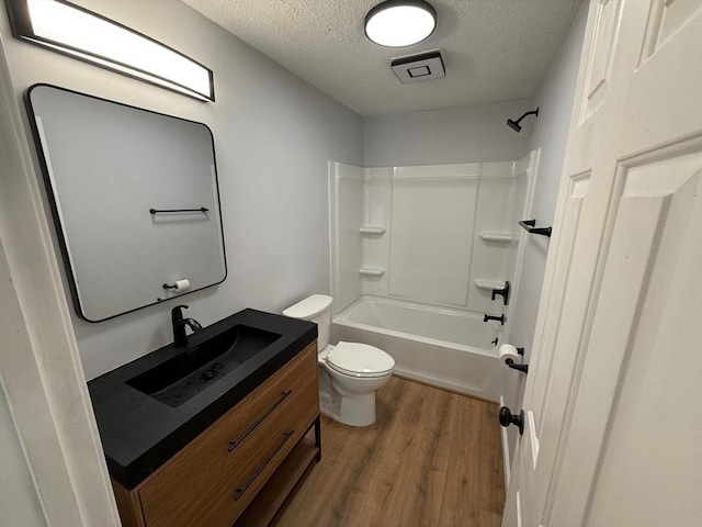 100 Cass Ave Unit B20, Dracut, MA 01826 - bathroom with a textured ceiling, wood finished floors, vanity, and  shower combination