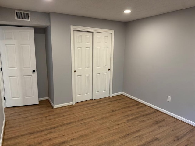100 Cass Ave Unit B20, Dracut, MA 01826 - unfurnished bedroom featuring recessed lighting, wood finished floors, and a closet
