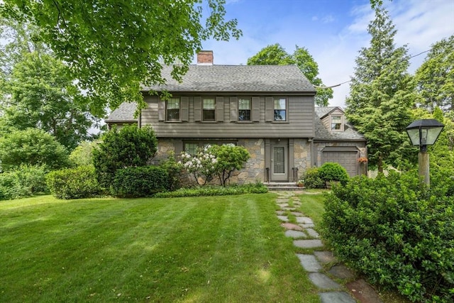 20 Johnson Rd, Andover, MA 01810 - view of front of property with stone siding, a front yard, an attached garage, a chimney, and a shingled roof