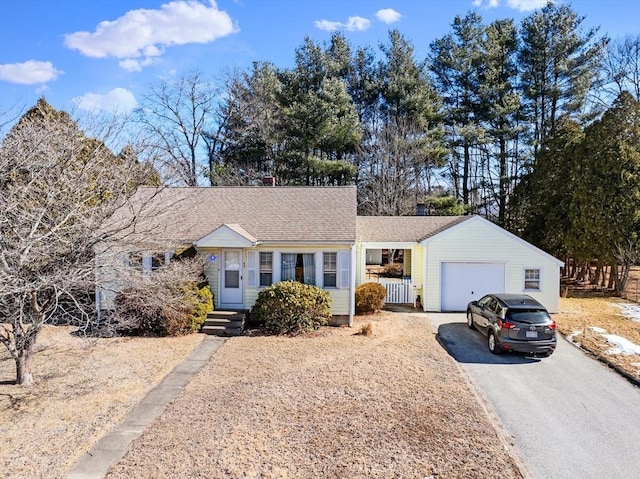 single story home with aphalt driveway, roof with shingles, an attached garage, and entry steps